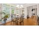 Cozy breakfast nook with many windows, glass top table and chandelier at 101 Kenmare Row, Tyrone, GA 30290