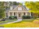 Charming home with a welcoming front porch, landscaped yard, and beautiful architectural details at 101 Kenmare Row, Tyrone, GA 30290