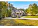 Beautiful two-story home with a well-manicured lawn and driveway in a serene, wooded setting at 101 Kenmare Row, Tyrone, GA 30290