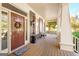Inviting front porch featuring a stained wood deck, seating and a welcoming front door at 101 Kenmare Row, Tyrone, GA 30290