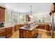Open kitchen featuring an island, stainless steel appliances, and hardwood floors at 101 Kenmare Row, Tyrone, GA 30290