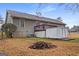 View of the backyard with green grass, shed, small deck, and a home with windows and a chimney at 3645 Fay Dr, Rex, GA 30273