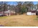Spacious backyard with a shed, mature trees, lush lawn, and view of the home's exterior at 3645 Fay Dr, Rex, GA 30273