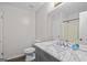 Bathroom features gray vanity with marble countertop, toilet, sink and mirror at 3645 Fay Dr, Rex, GA 30273
