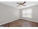 Bedroom features wood-look floors, ceiling fan and bright window at 3645 Fay Dr, Rex, GA 30273