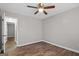This bedroom features sleek hardwood floors, a ceiling fan, neutral paint and a doorway leading to another room at 3645 Fay Dr, Rex, GA 30273