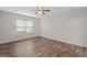 This is a bedroom with a ceiling fan and wood-look flooring at 3645 Fay Dr, Rex, GA 30273