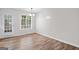 Bright dining area featuring hardwood floors, white trim, modern lighting, and backyard access at 3645 Fay Dr, Rex, GA 30273