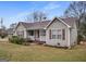 Charming single-story home with neutral siding, red shutters, a brown roof, and a cozy front porch at 3645 Fay Dr, Rex, GA 30273