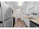 Functional kitchen featuring white cabinets, stainless steel appliances, and modern flooring at 3645 Fay Dr, Rex, GA 30273