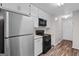 Efficient kitchen featuring white cabinets, stainless steel appliances, and modern flooring at 3645 Fay Dr, Rex, GA 30273