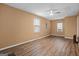 Spacious living room with hardwood floors, two windows that let in plenty of natural light, and a ceiling fan at 3645 Fay Dr, Rex, GA 30273