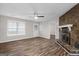 Bright living room featuring hardwood floors, a stone fireplace, a ceiling fan, and backyard access at 3645 Fay Dr, Rex, GA 30273