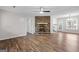 Spacious living room with hardwood floors, a stone fireplace, and a ceiling fan at 3645 Fay Dr, Rex, GA 30273