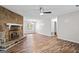 Bright living room featuring hardwood floors, a stone fireplace, a ceiling fan, and neutral wall paint at 3645 Fay Dr, Rex, GA 30273