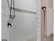 Modern shower with white tile walls and decorative accent border at 283 Shoemake Rd, Carrollton, GA 30116