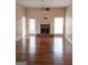 Bright living room featuring hardwood floors, a cozy fireplace, and ample natural light at 245 Wisteria Blvd, Covington, GA 30016