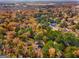 Aerial view of a property and the tree canopy during the fall, with peeks of nearby homes and community at 425 Meadowbrook Dr, Mcdonough, GA 30253