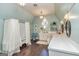Bright bathroom with a vintage bathtub, wood floors, and stylish fixtures at 86 Victoria Dr, Moreland, GA 30259