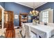 Charming dining room featuring a fireplace, wood floors, and classic chandelier lighting at 86 Victoria Dr, Moreland, GA 30259