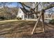 Charming two-story home with a white picket fence supported by a tree trunk at 86 Victoria Dr, Moreland, GA 30259