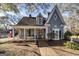 Charming two-story home featuring unique architecture and a inviting front porch at 86 Victoria Dr, Moreland, GA 30259