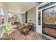 Inviting front porch with brick flooring, wicker furniture, a swing, and charming decor at 86 Victoria Dr, Moreland, GA 30259