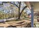 Landscaped front yard with a mature tree, white picket fence, and view of the home's charming facade at 86 Victoria Dr, Moreland, GA 30259