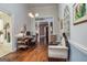 Hallway with hardwood floors, leading to an office with custom desk and a view to other rooms at 86 Victoria Dr, Moreland, GA 30259