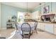 Bright kitchen with white cabinets, a table with chairs, and tile flooring at 86 Victoria Dr, Moreland, GA 30259