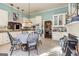 Sunny kitchen with an eat-in area, white cabinets, and modern appliances at 86 Victoria Dr, Moreland, GA 30259
