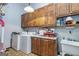 Functional laundry room with washer, dryer, storage cabinets and utility sink at 86 Victoria Dr, Moreland, GA 30259