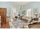 Comfortable living room featuring hardwood floors, fireplace, and unique lighting fixture at 86 Victoria Dr, Moreland, GA 30259