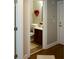 Bathroom with hardwood floors, dark wood cabinets, white walls, and a decorative heart hanging on the wall at 6422 Paulson, Atlanta, GA 30328