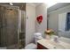 Bathroom featuring tiled shower, vanity with sink, and decorative heart on the wall at 6422 Paulson, Atlanta, GA 30328