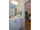 Bathroom featuring a white vanity, mirror, and doorway view to bedroom at 6422 Paulson, Atlanta, GA 30328