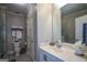 A well-lit bathroom featuring a white vanity and a glass shower at 6422 Paulson, Atlanta, GA 30328