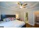 Comfortable bedroom features a tray ceiling, ceiling fan, and ensuite bath with walk-in shower at 6422 Paulson, Atlanta, GA 30328