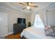 This inviting bedroom features hardwood floors, a ceiling fan, and a large dresser at 6422 Paulson, Atlanta, GA 30328