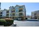 Exterior view of multi-story townhome building with balconies and well-maintained landscaping at 6422 Paulson, Atlanta, GA 30328