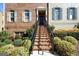 Inviting front entrance with brick stairs, black railing, and lush landscaping at 6422 Paulson, Atlanta, GA 30328