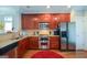 Well-equipped kitchen with stainless steel appliances, rich wood cabinets, and granite countertops at 6422 Paulson, Atlanta, GA 30328