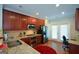 Well-lit kitchen features stainless steel appliances, granite countertops, and dark wood cabinetry at 6422 Paulson, Atlanta, GA 30328