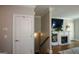 Living room view with fireplace, tv, stairs to basement, hardwood floors and white trim at 6422 Paulson, Atlanta, GA 30328