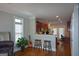 Open living space flows into kitchen area with bar seating and a view of the desk area at 6422 Paulson, Atlanta, GA 30328