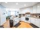 Bright kitchen featuring white cabinets, granite countertops, and stainless steel appliances at 700 Brand South Trl, Lawrenceville, GA 30046