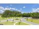 Aerial view of the community featuring a roundabout, lush trees and landscaping at 8591 Seabiscuit Rd # 113, Lithonia, GA 30058