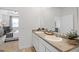 Bathroom features a dual sink vanity with a view into the Primary bedroom at 8591 Seabiscuit Rd # 113, Lithonia, GA 30058