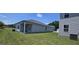 View of the rear of the home showing the patio with support columns and AC unit at 8591 Seabiscuit Rd # 113, Lithonia, GA 30058