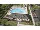 Aerial view of community pool with lounge chairs, umbrellas, and a covered pavilion area at 8591 Seabiscuit Rd # 113, Lithonia, GA 30058